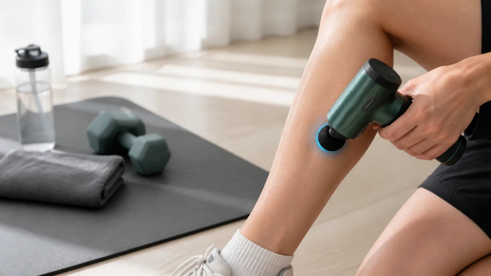 hot and cold massage gun using a cool thermal head on the calf after exercise